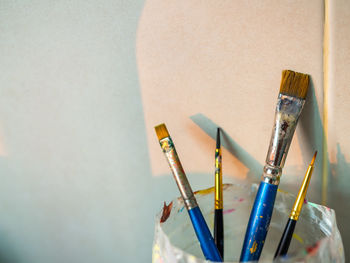 Close-up of paintbrushes on wall