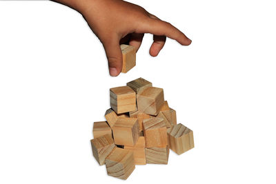 Hand holding toy against white background