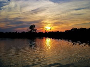 Scenic view of lake against orange sky