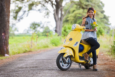 Vietnamese woman with yellow scooter in rural area in vietnam