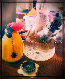 Close-up of multi colored bottles on table