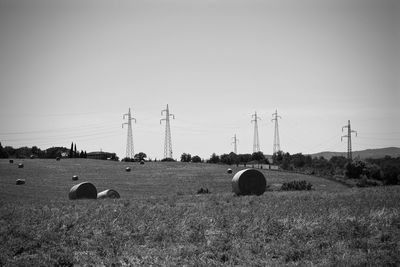 Hay bales on field against sky