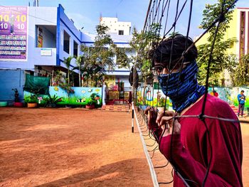 Rear view of woman standing on street