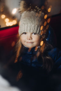 Close-up portrait of cute girl wearing knit hat