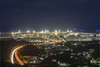 High angle view of illuminated buildings in city at night