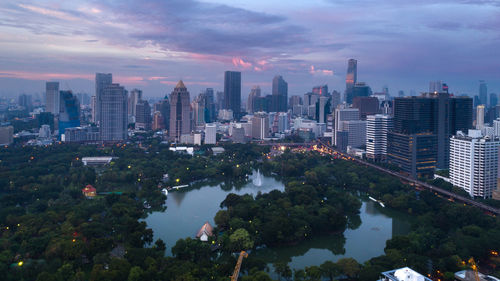 Aerial view of buildings in city against sky