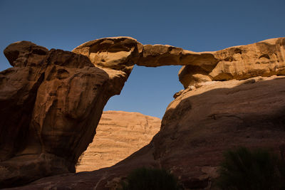 Low angle view of rock formations against sky