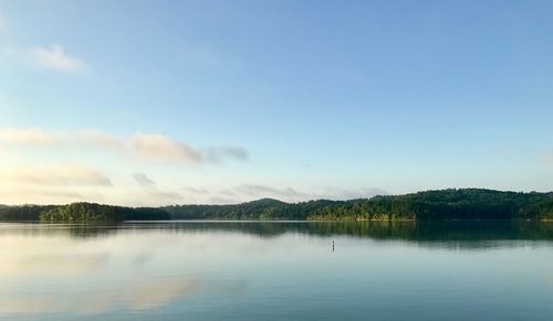 Scenic view of lake against blue sky