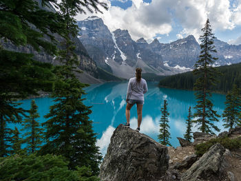 Rear view of woman looking at lake and mountains