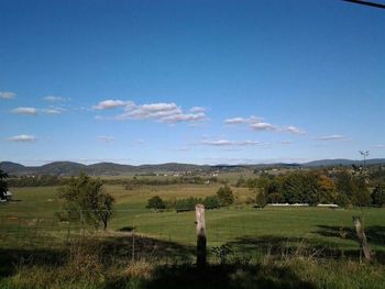 Scenic view of grassy field against cloudy sky