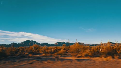 Scenic view of mountains against blue sky