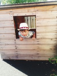 Portrait of cute boy on wood