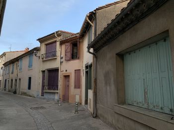 Empty street amidst buildings in city