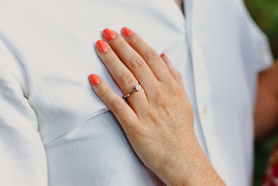 Cropped hand of woman touching chest