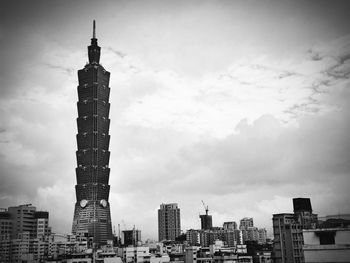 View of skyscrapers against cloudy sky