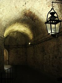 Low angle view of illuminated lighting equipment hanging on ceiling