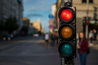 Close-up of traffic signal on road in city