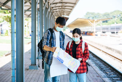 Friends standing on railroad station platform