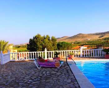 Calm sea against clear blue sky
