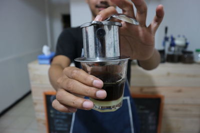Close-up of hand holding coffee cup