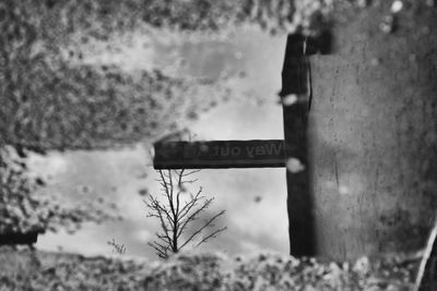 Close-up of road sign against sky