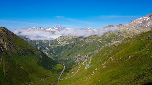 Scenic view of snowcapped mountains against blue sky