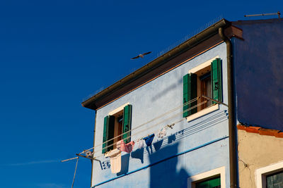 Low angle view of building against clear blue sky