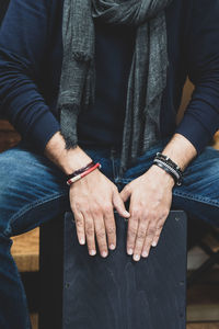 Midsection of couple holding hands