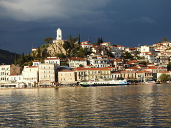 View of townscape by sea against sky