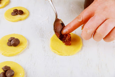 High angle view of person preparing food on table