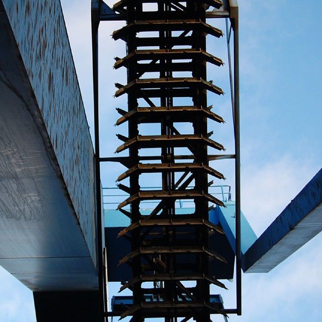 architecture, built structure, low angle view, connection, bridge - man made structure, engineering, sky, modern, building exterior, city, bridge, metal, no people, day, tower, transportation, blue, outdoors, tall - high, metallic