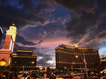 Low angle view of illuminated buildings against sky at night