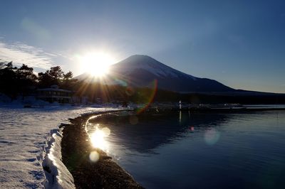 Scenic view of mt fuji by lake against sky during winter