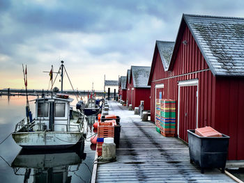 Houses at harbor against sky