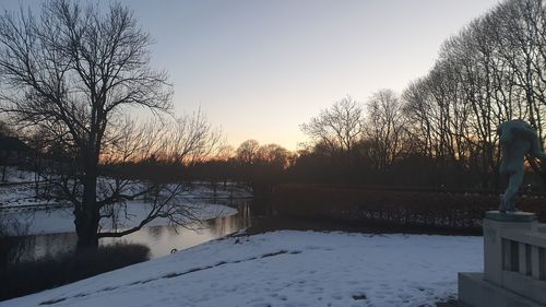 Scenic view of frozen lake against sky during sunset