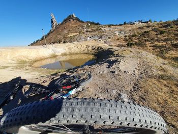 Midsection of person on rock against sky