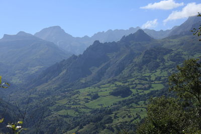 Scenic shot of countryside landscape against mountain range