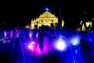 People enjoying concert at night