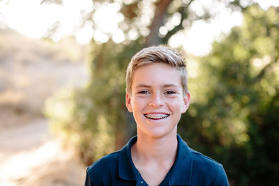 Smiling portrait of a young teen boy with braces