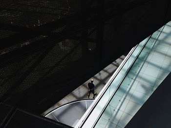 High angle view of man walking on sidewalk