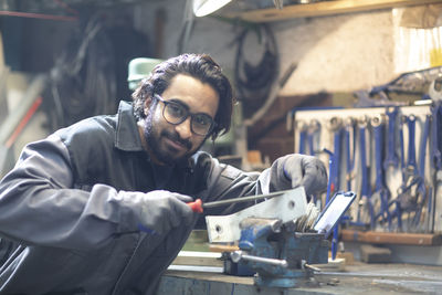 Young plumber technician working in workshop