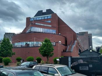 View of modern building against cloudy sky