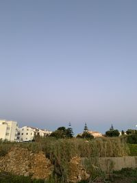 Panoramic shot of buildings against clear sky