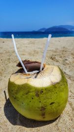 Close-up of drink on table at beach