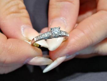 Close-up of woman hands holding diamond ring