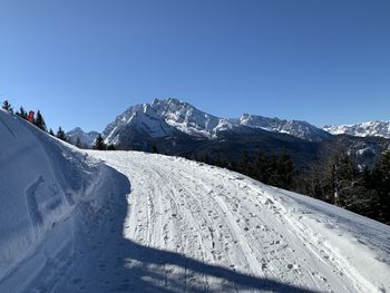 Low angle view of snow covered mountain against sky in berchtesgaden 