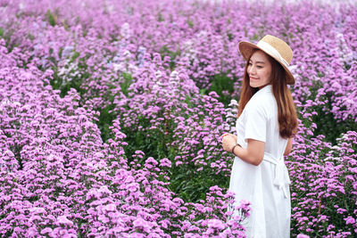 Portrait image of a beautiful young asian woman in margaret flower field