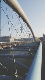 Low angle view of suspension bridge against sky