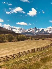 Scenic view of field and mountains against sky