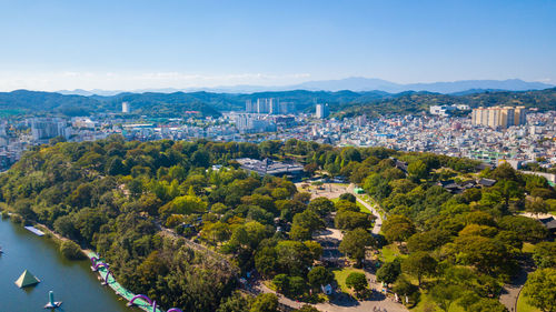 High angle view of buildings and trees against sky